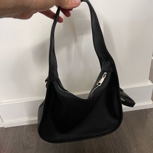 Black shoulder bag with mini bag attached